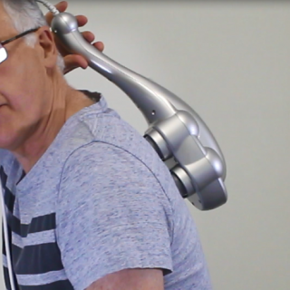 Using the handle of the Ultimate Quad Head Massager